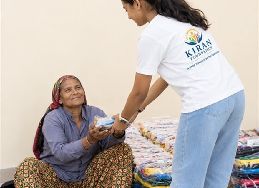A Kiran Foundation volunteer with a woman and her child